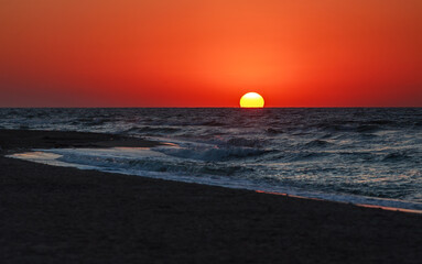Spectacular colorful sky clouds sunset in summer on sea coast
