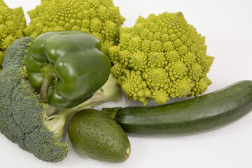 fresh green food, green vegetable, romanesco broccoli, pepper, zucchini and avocado on a isolated Background