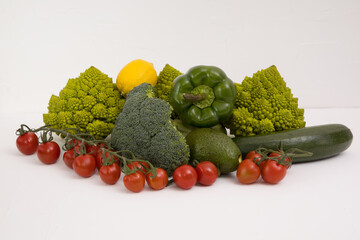 fresh vegetable, romanesco, pepper, zucchini, avocado, cherry tomato and lemon free space in your text, on a isolated background