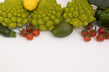 fresh vegetable, romanesco, pepper, zucchini, avocado, cherry tomato and lemon free space in your text, on a isolated background