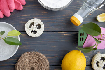 The concept of eco-friendly home cleaning. Various items and ingredients for eco-cleaning the house on a wooden background with space for text.