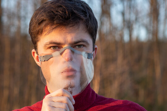 Young Man In Face Shield. Man Wearing Face Visor. Foggy Face Visor Shield. Coronavirus, Covid. Face Covered With Transparent Mask.