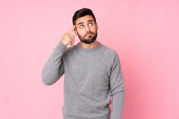 Caucasian handsome man over isolated background making the gesture of madness putting finger on the...