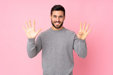 Caucasian handsome man over isolated background counting nine with fingers