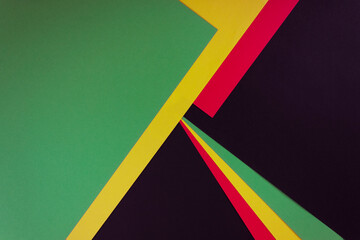 Obraz premium Red, yellow and green color paper on the black background. Black History Month concept. Flat lay. Copy space.