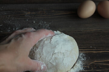 Hand knead the dough on a wooden board.