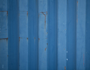 Blue grungy corrugated metal wall of industrial container rusty and old for metallic background striped with vertical lines g=horizontal format