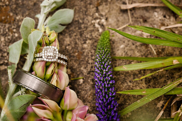 Beautiful diamond wedding rings over a bridal bouquet