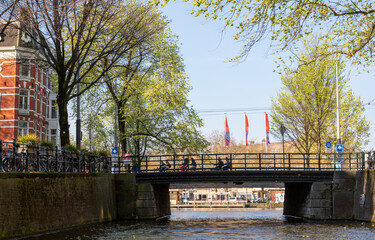 Europe, Netherlands, Amsterdam. Bicycles on bridges over canal.
