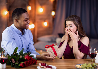 Romantic Surprise. Affectionate Black Man Giving Present To His Excited White Girlfriend