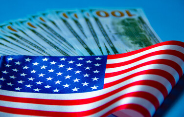 Close up of american flag and dollar cash money. Dollar banknote and United States flag background. Economy of USA
