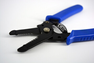 Metal plassentes with blue plastics handles for trimming wires of different diameter located on a...