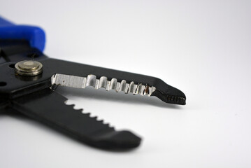 Metal plassentes with blue plastics handles for trimming wires of different diameter located on a...