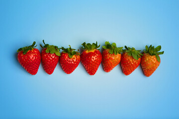 Strawberry on a flat and blue background