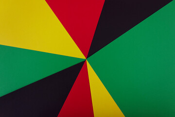 Red, yellow and green colors papers on the black background. Black History Month concept. Flat lay. Copy space. 