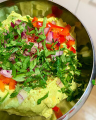 avocado paste, creamy avocado paste with tomatoes, parsley, sliced red pepper, vegetarian dish, green paste