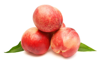 Heap of whole peaches with leaves isolated on white background