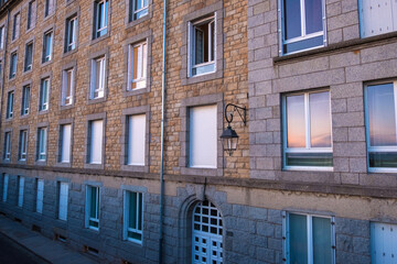 View at sunset from the wall of the old city with granite buildings of Saint-Malo in Brittany, France