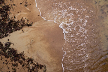 Sandy beach and waves. View from above.