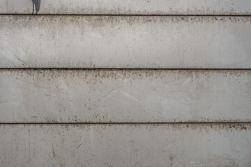 abstract background of an old wall decorated with painted grey metal panels