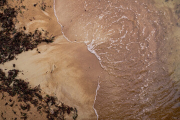 Sandy beach and waves. View from above.