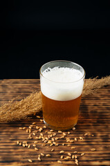 Glass beer on wood background with copyspace
