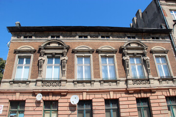 Fototapeta na wymiar Historic building made of red bricks and big glass windows
