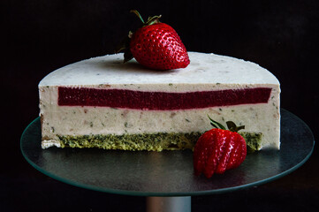 Beautiful photo cut of a cake on a dark background.