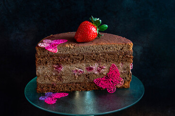 Beautiful photo cut of a cake on a dark background.