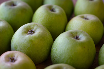 Apples stand on a wooden surface