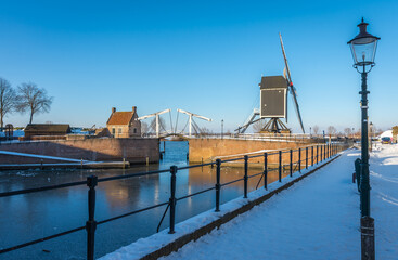 Winter scenery with a tow bridge and a windmill in Heusden, picturesque town in Province North Brabant, The Netherlands
