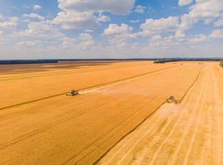 Harvesting machine working in the field. Top view from the drone Combine harvester agricultural...