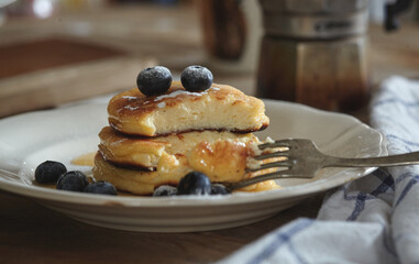 Delicious homemade cheesecakes, cut with a fork sprinkled with fresh blueberries,