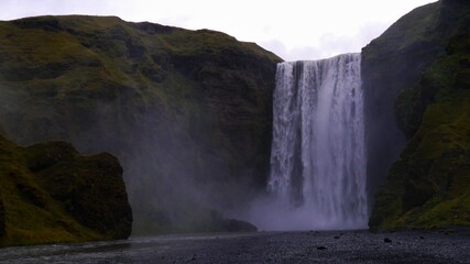 a waterfall with a mountain in the background