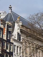 Netherlands, Amsterdam. Ornate top of a traditional Dutch home along the canal in Amsterdam.