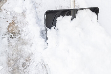 Snow cleaning with a large shovel in winter