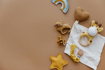  Set of baby stuff and accessories for newborn on brown background. Baby shower or baby care  concept. Flat lay, top view