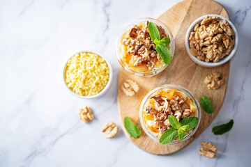 Greek yogurt millet caramelized apple walnuts parfait in a glass