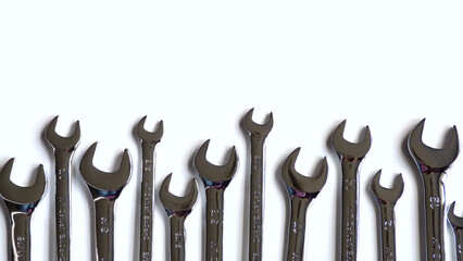 An Alternating Line of Metallic Wrenches Isolated on a White Background | A Line of Tools