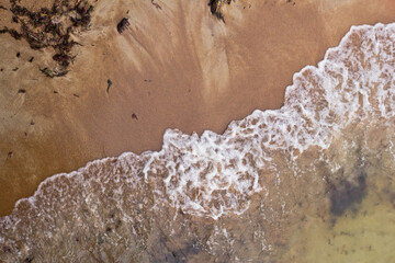 Sandy beach and waves. View from above.