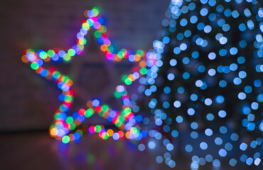 multicolored festive bokeh out of focus in the shape of a star, suitable for text in the foreground