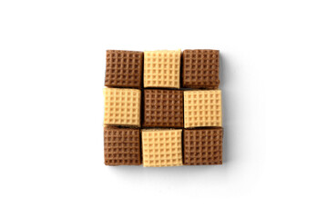 Chocolate and creamy toffee candy squares isolated on white background. Top view.