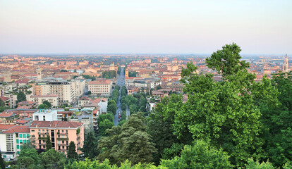Fototapeta na wymiar Panorama of Bergamo (Italy). Buildings with red tiled roofs and main road.