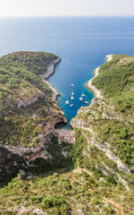 Fototapeta na wymiar Aerial drone shot of iconic Stiniva cove beach of Adriatic sea on Vis Island in Croatia summer