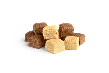 Heap of chocolate and creamy toffee candy squares isolated on white background.