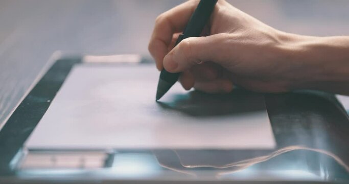Closeup of designer drawing using a graphics tablet and stylus pen