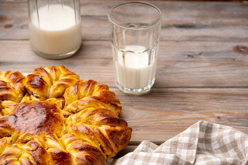 Apple and cinnamon star braided bread. Yeast cake. Glass of milk.