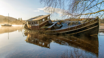sunken old wooden boat on a scottish loch