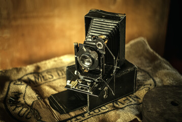 Vintage folding camera with leather accordion, fotokor 1. Photo in retro style.