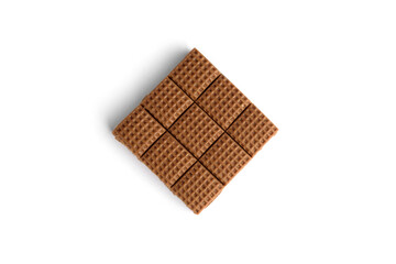 Chocolate toffee candy squares isolated on white background. Top view.